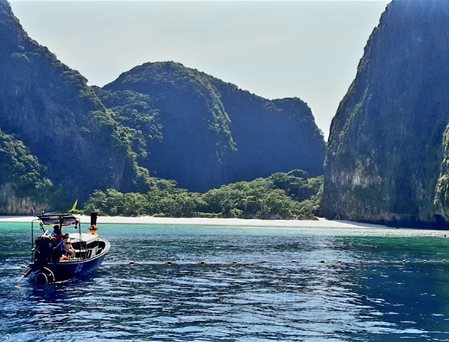 Maya Bay cliffs, beach and turquoise water, photographed by Phuket Island Charters