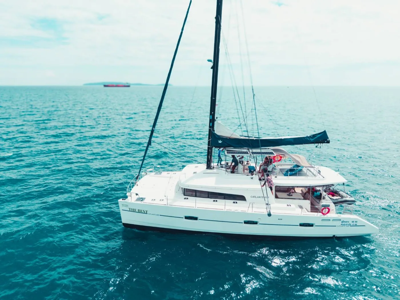 A broadside view of the Catalante 60 sailing catamaran under sail.