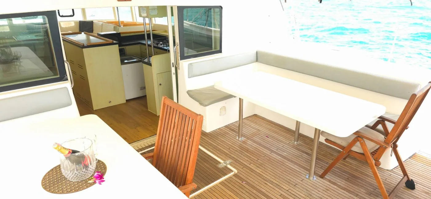 Outdoor table and seating aboard the Catalante.